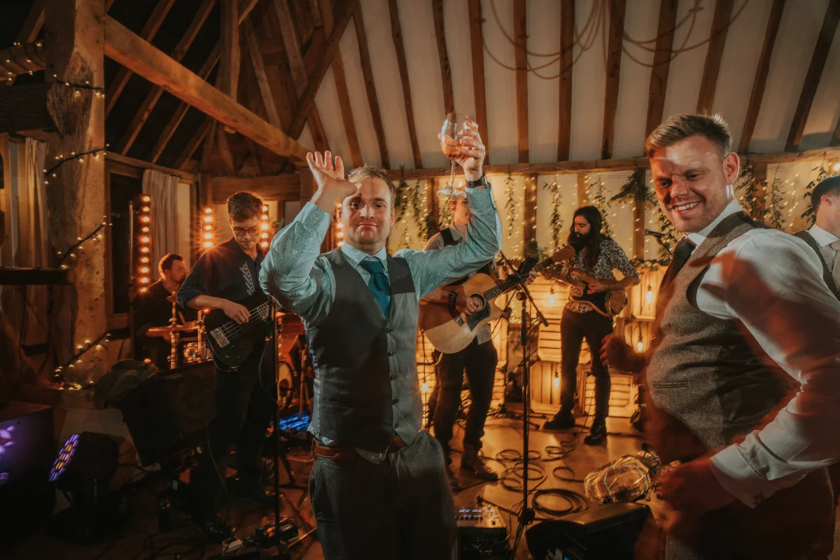 Kinmara performing at a rustic barn wedding in Surrey with guests dancing