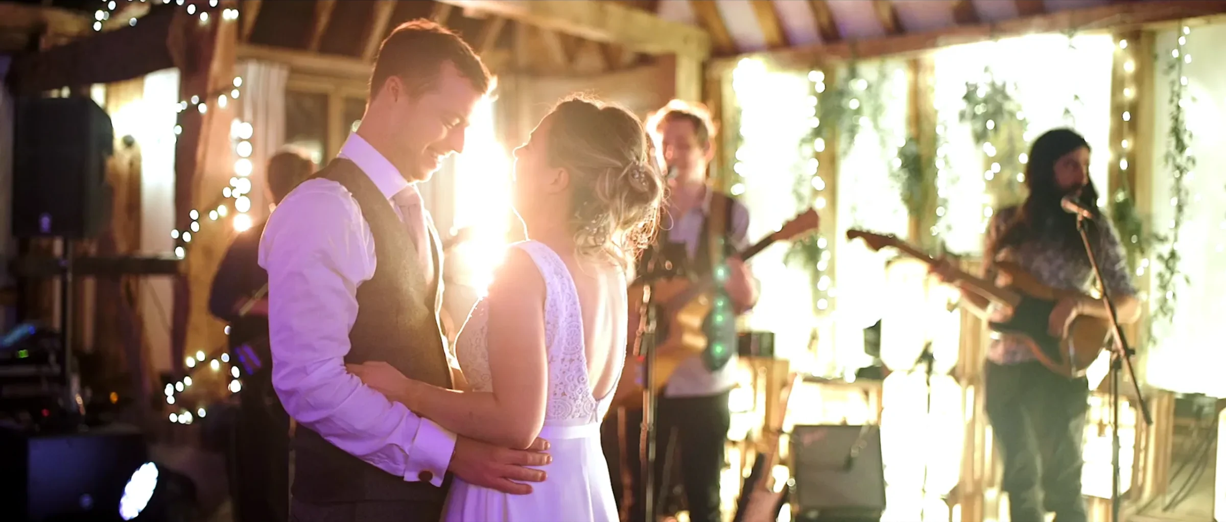 A couple dancing their first dance while Kinmara play behind them