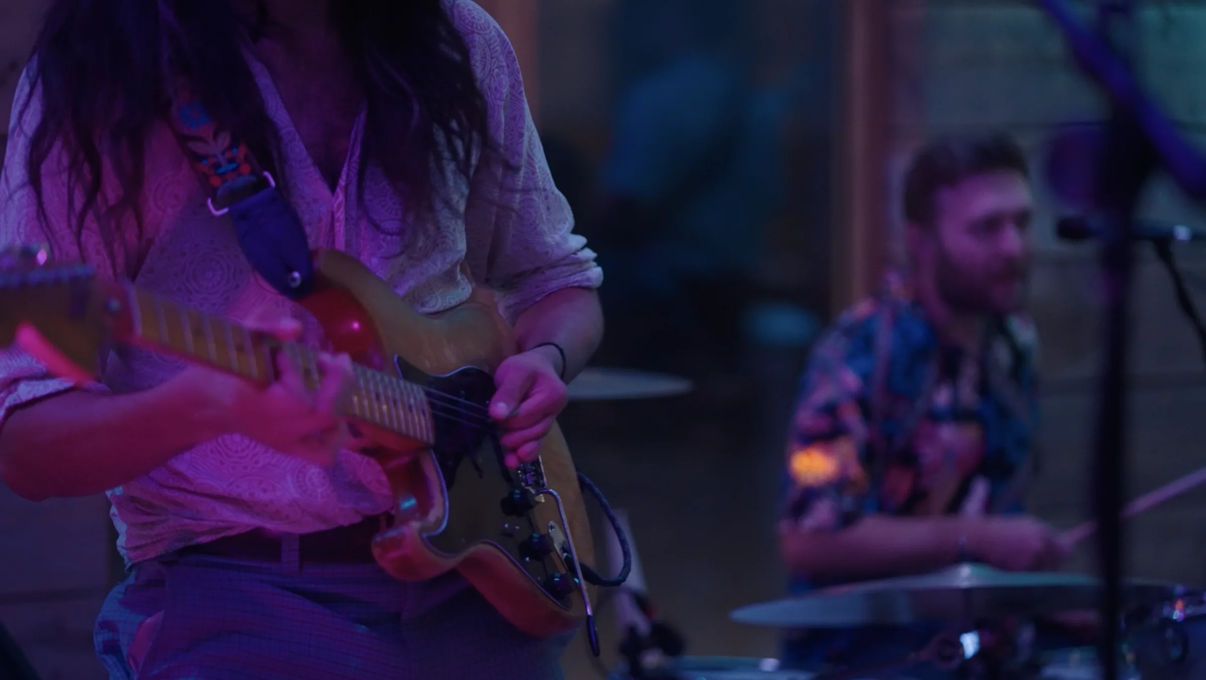 Kinmara's guitarist and drummer mid-set under stage lights